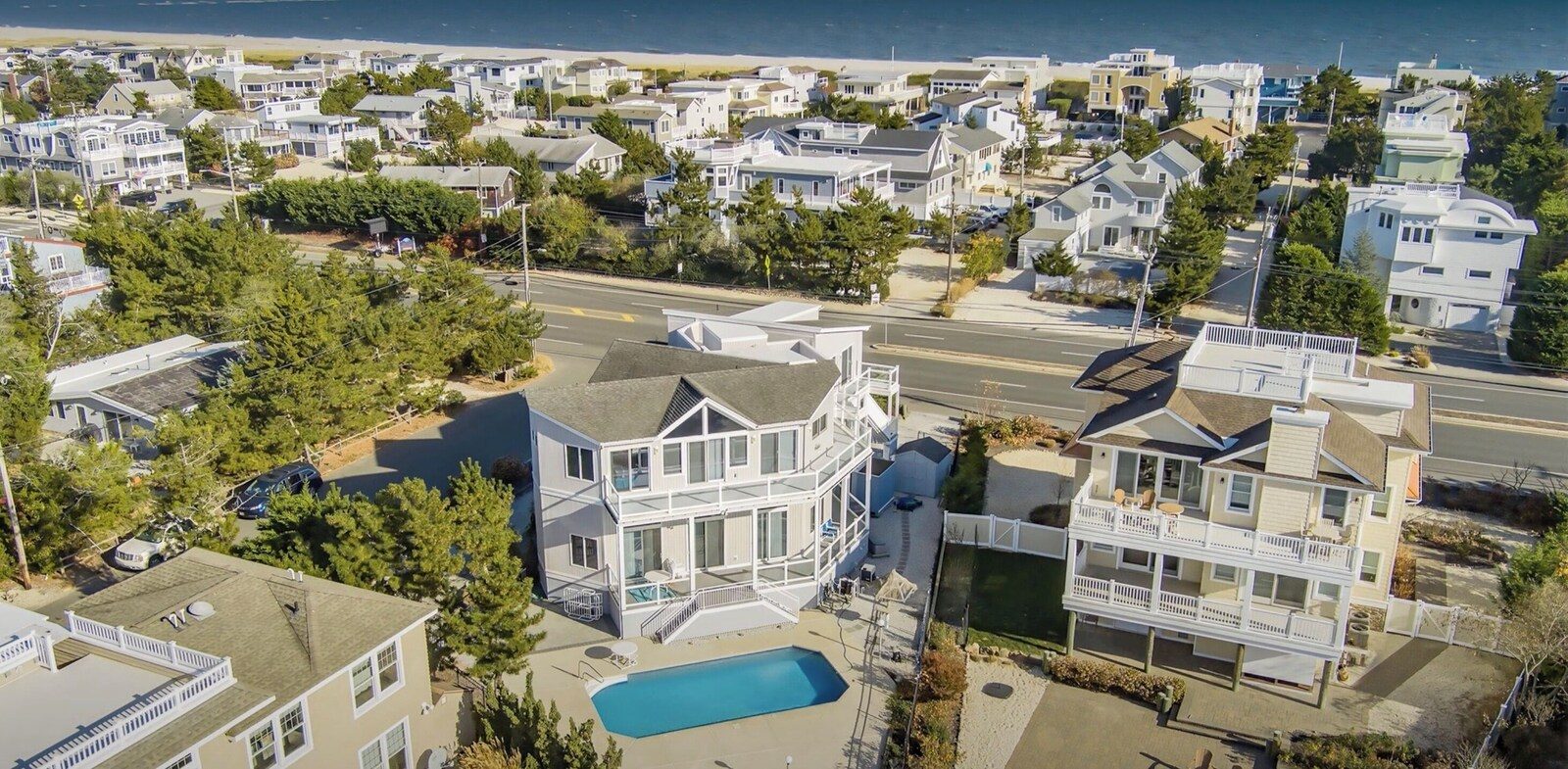 Aerial view of the Loveladies home, pool, and lagoon